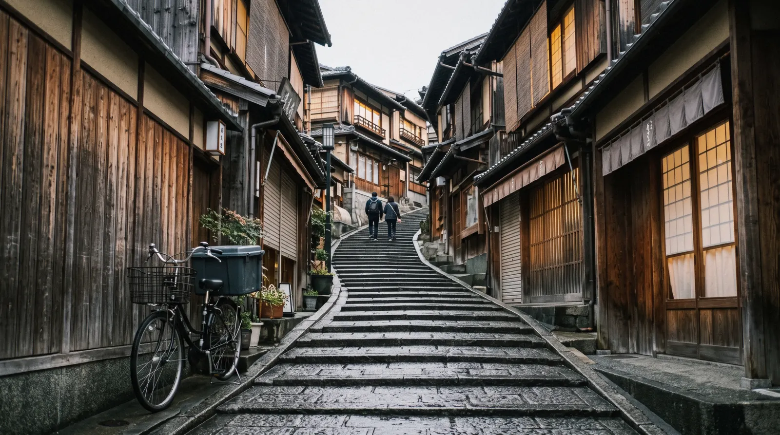 The stone steps of Sannenzaka lined with wooden shopfronts at 07:15 with the shutters still down, Higashiyama Kyoto Japan