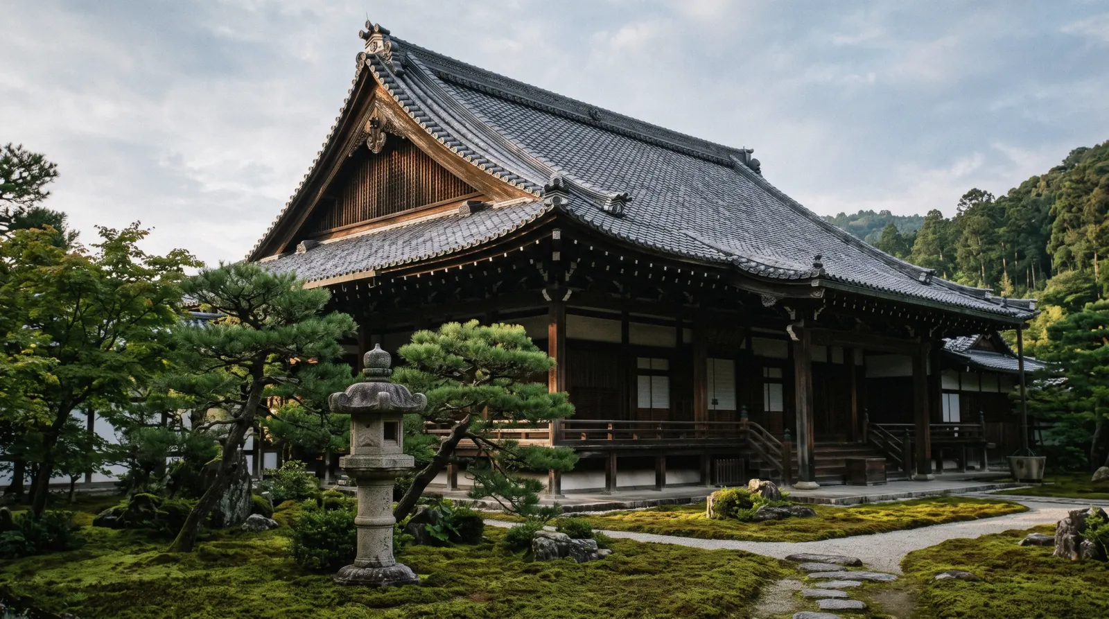A temple hall roof above moss and pines in early morning light, Kyoto temples Japan