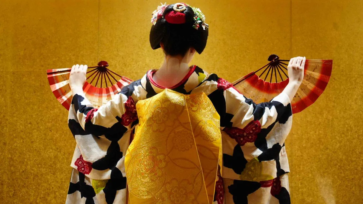 Maiko performing a seated dance in a tatami room at a Kyoto geisha show, Kyoto Japan