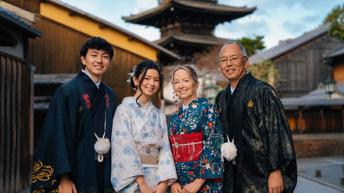Visitors in rented kimono walking a stone lane in Higashiyama, Kyoto Japan